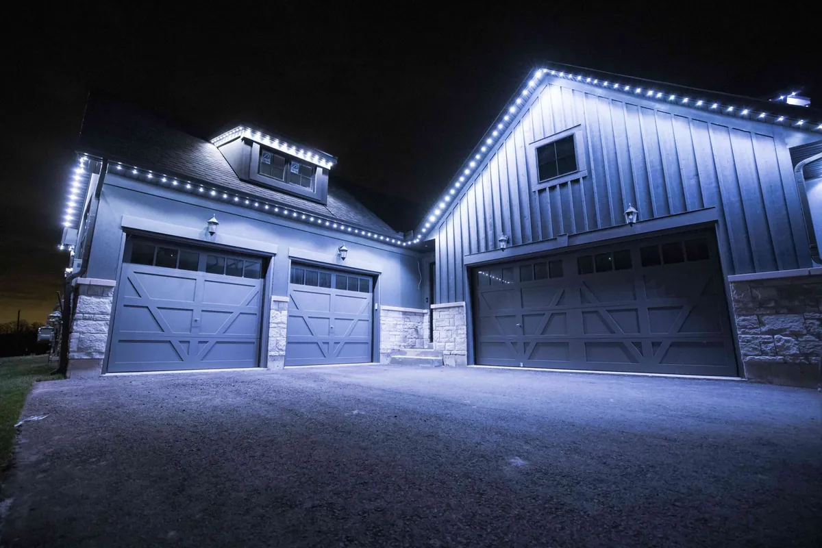 Crisp white permanent lighting on a garage and entry