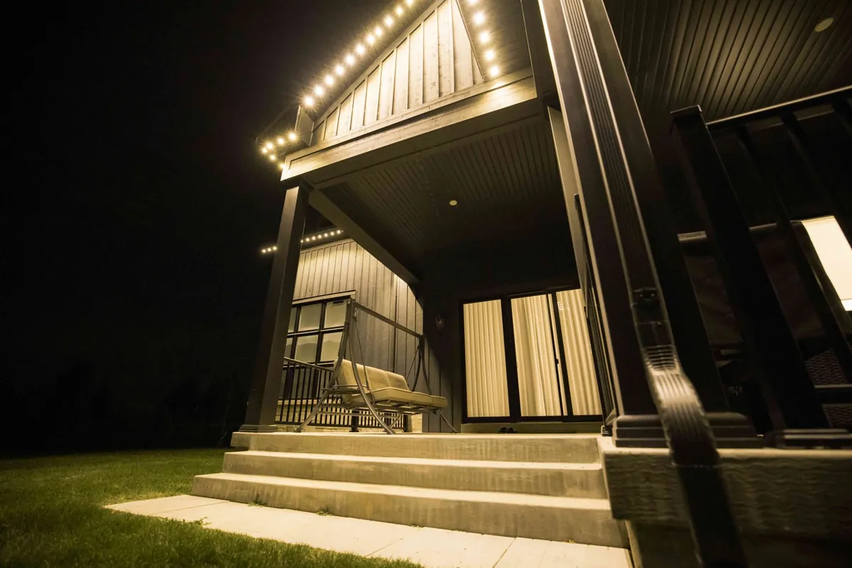 Warm white permanent lights along a covered porch